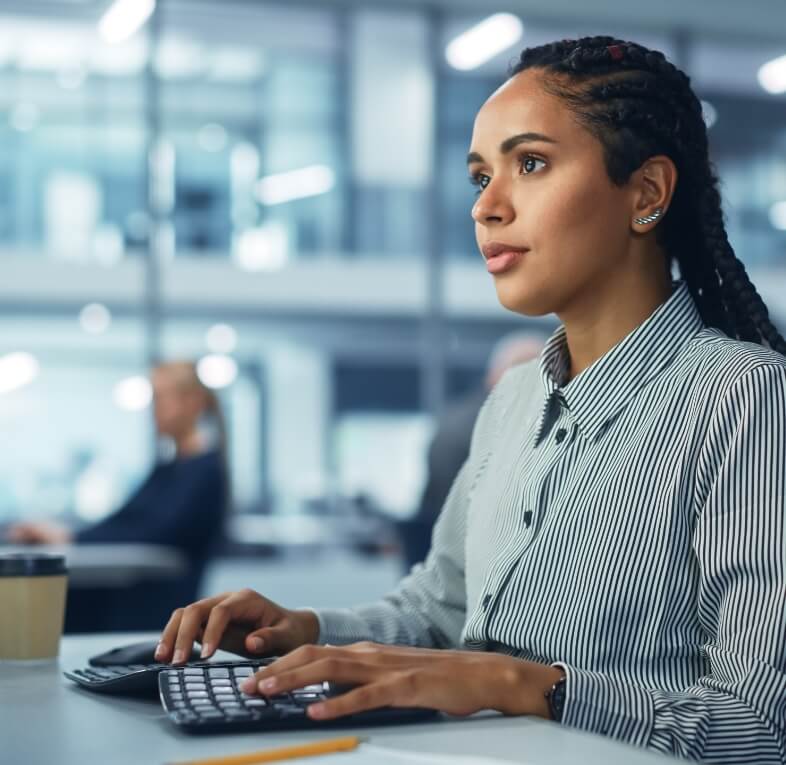 Woman typing at computer